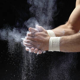 Male Gymnast Powdering Hands, Close-up by Ray Massey