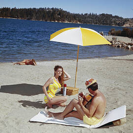 Man Playing Guitar While Woman Dancing by Tom Kelley Archive
