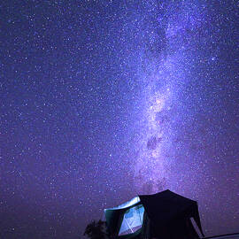 Milky way over a tent on the roof of a pickup car in the Namib desert of Namibia by Miroslav Liska