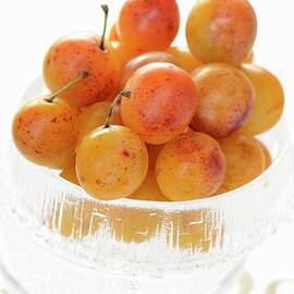 Mirabelle Plums In A Glass Bowl by Alain Caste