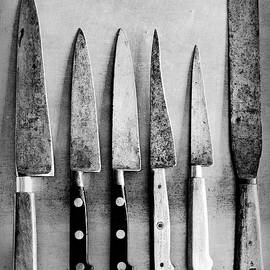 Old Kitchen Knives On A Metal Surface by Jamie Watson