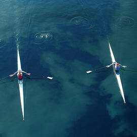 People Rowing Sculling Boats On River by Blend Images pete Saloutos