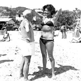 Picasso And Bikini-clad Woman On The by Hulton Archive