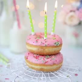 Pink Doughnuts With Birthday Candles by Dorota Ryniewicz