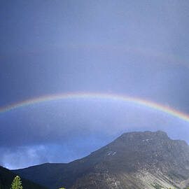 Rainbow Over Mountains by Ascent pks Media Inc.