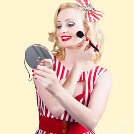 Retro pin-up woman doing beauty make-up by Jorgo Photography
