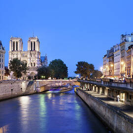 Seine River And Notre Dame Cathedral At by Raimund Koch