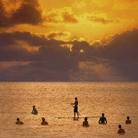 Silhouette Of Surfers In Sea, Rear View by Ed Freeman