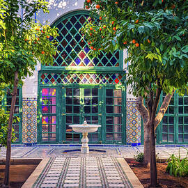 Small white fontaine among orange trees of Jardin Majorelle, Marrakech, Morocco by Miroslav Liska