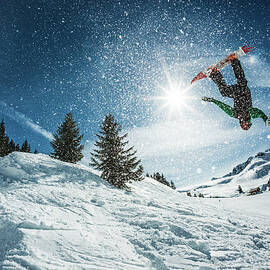 Snowboarder Doing A Backflip With Snow by A Francois Marclay