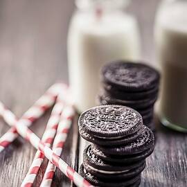 Stacks Of Oreo Cookies With Milk Bottles And Drinking Straws On A Wooden Slab by Susan Brooks-dammann