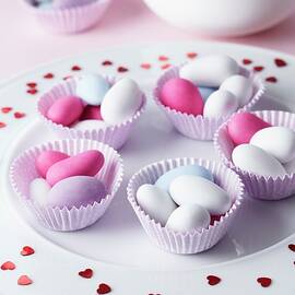 Sugared Almonds In Muffin Cases On A Plate Scattered With Hearts For A Wedding by Taube, Franziska