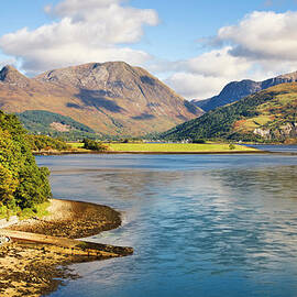 Sunlit Mountains Seen Across A Loch by Simon Butterworth