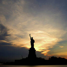 Sunset Over The Statue Of Liberty, New York, Usa by Michael Boyny