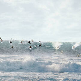 Surfers Surfing On Wave by Ed Freeman