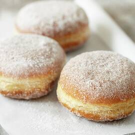 Three Doughnuts On A Piece Of Paper by Till Melchior