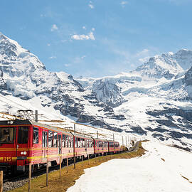 Train Passing Through Alps by Jordan Banks