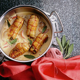 Turkey Roulade Stuffed With Ham, Mushrooms And Sage In Mushroom Sauce In Pan by Jalag / Sven C. Raben
