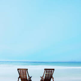 Two Beach Chairs On Tropical Beach At by Thomas Barwick