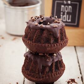 Two Chocolate Bundt Cakes On Top Of Each Other In A Food Truck by Eising Studio - Food Photo & Video