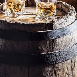 Two Glasses Of Whisky With Ice On An Old Wooden Barrel by Shaiith