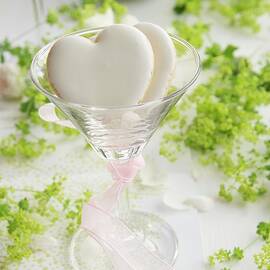 Two Heart-shaped Biscuits In A Cocktail Glass by Schindler, Martina