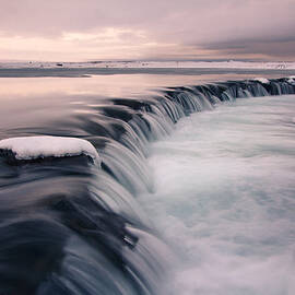 Waterfall In Winter During Sunset by IngAlfur Bjargmundsson
