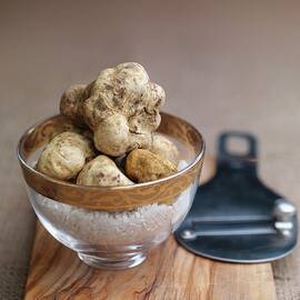 White Truffles In A Glass Bowl On A Wooden Board by Rob Whitrow