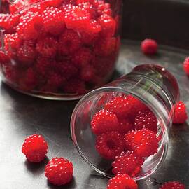 Wild Raspberries Spilling Out Of A Glass by Katharine Pollak