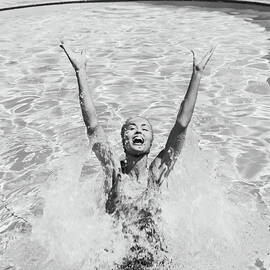 Woman Having Fun In Swimming Pool by Tom Kelley Archive