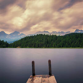 Wooden pier at the Lake of Staz near St. Moritz in Switzerland by Miroslav Liska