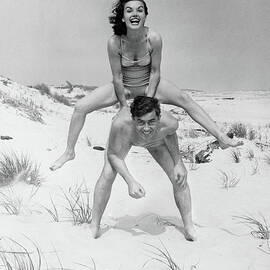 Young Couple On Beach, Woman by George Marks