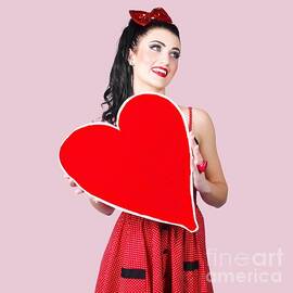 Young lady holding retro red heart card by Jorgo Photography