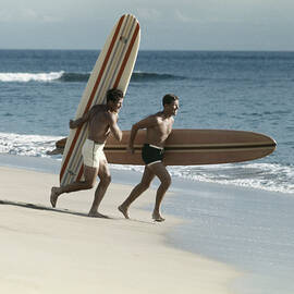 Young Men Running On Beach With by Tom Kelley Archive