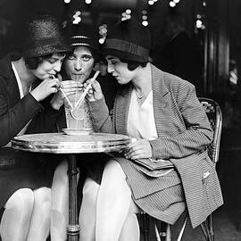 Young Women Having A Drink by Keystone-france