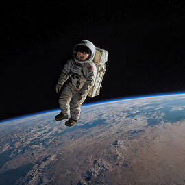 Astronaut Floating Above Earth by The Luxury Art Collection