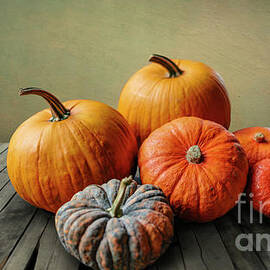 Autumn pumpkins still life on vintage wooden table and rustic ba by Jelena Jovanovic