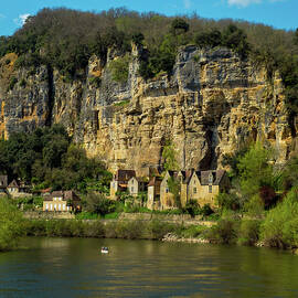 Canoes pass La Roque-Gageac on the Dordogne River by Seeables Visual Arts