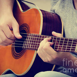 Man plays the guitar by Jelena Jovanovic