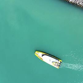 A boat heading out of harbour in Whitsundays, Australia by Andre Petrov