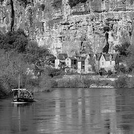 A sightseeing boat passes La Roque-Gageac on the Dordogne River by Seeables Visual Arts