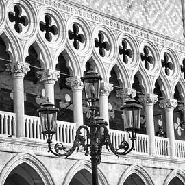 A typical Venetian street lamp in front of the Ducal Palace windows  by Stefano Senise