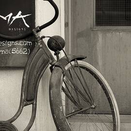 Aged Bicycle Resting by the Wall by Travel Essayist