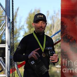 Athlete Holding Medal and Trophy 3579 by Donn Ingemie
