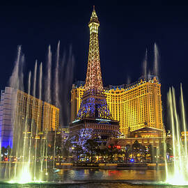 Bellagio Fountain water show at night with Paris Las Vegas Hotel and Casino by Miroslav Liska