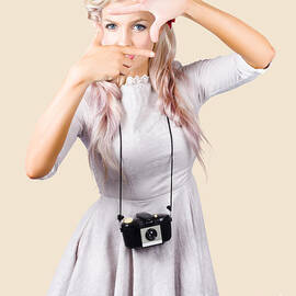 Blond woman framing picture by Jorgo Photography