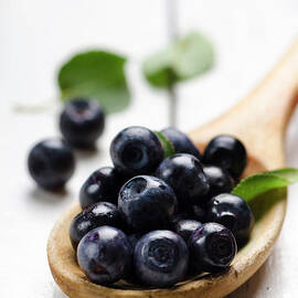 Blueberry in wooden spoon by Jelena Jovanovic