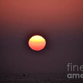 Boat under Fire Sunset by Debra Banks