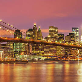 Brooklyn Bridge and Manhattan Skyline at night, New York, USA by Neale And Judith Clark