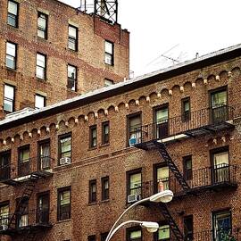 Classic Brick Apartment Building Beneath Cloudy New York Sky by Travel Essayist